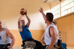 handicapped war veterans in wheelchairs with professional equipment play basketball match in the hall.the concept of sports with disabilities photo