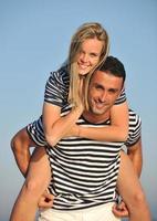 happy young couple have romantic time on beach photo