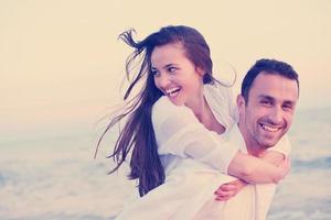 young couple  on beach have fun photo