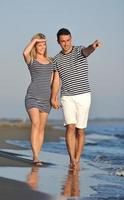 happy young couple have romantic time on beach photo