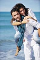 happy young couple have fun at beautiful beach photo