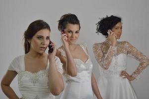 portrait of a three beautiful woman in wedding dress photo