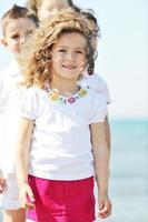 happy child group playing  on beach photo