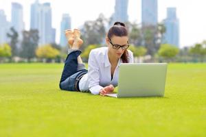 woman with laptop in park photo