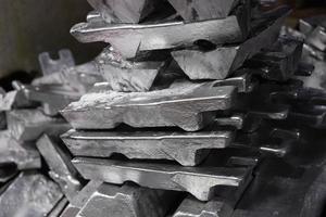 messy stack of aluminium ingots - close-up with selective focus photo