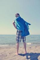 funny superhero standing on beach photo