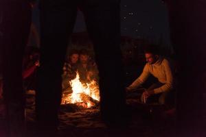 Friends having fun at beach on autumn day photo