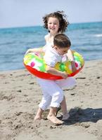 happy child group playing  on beach photo