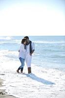 happy young couple have fun at beautiful beach photo