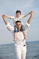 happy father and son have fun and enjoy time on beach photo