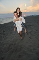 happy young couple have fun on beach photo