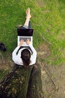 woman with laptop in park photo