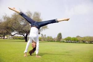 young woman jumping in park photo