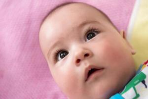 top view of newborn baby boy lying on colorful blankets photo