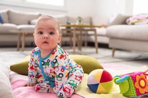 newborn baby boy sitting on colorful blankets photo