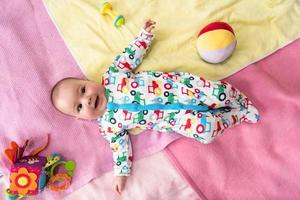 top view of newborn baby boy lying on colorful blankets photo