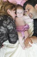 portrait of young family with  cute little babby photo