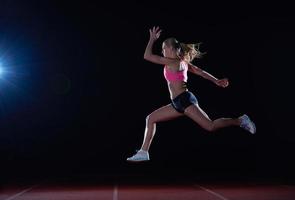 Athletic woman running on track photo