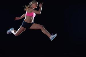 Athletic woman running on track photo