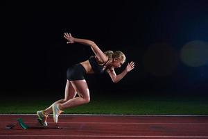 pixelated design of woman  sprinter leaving starting blocks photo