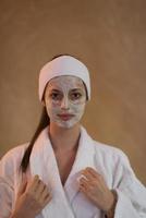 Spa Woman applying Facial Mask photo