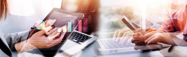 Businessman hands working with finances about cost and calculator and laptop with tablet, smartphone at office in morning light photo