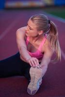 sporty woman on athletic race track photo