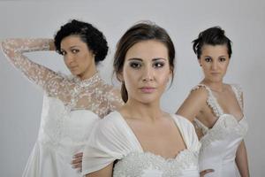 portrait of a three beautiful woman in wedding dress photo