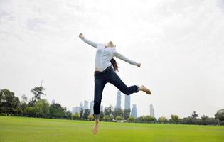 young woman jumping in park photo