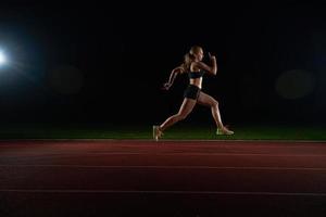 Athletic woman running on track photo