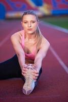 sporty woman on athletic race track photo