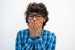 portrait of smart looking arab teenager with glasses wearing a hat in casual school look isolated on white copy space photo