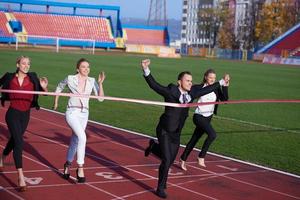 business people running on racing track photo