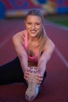 sporty woman on athletic race track photo