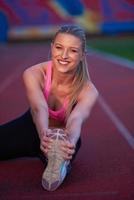 sporty woman on athletic race track photo