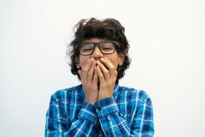 portrait of smart looking arab teenager with glasses wearing a hat in casual school look isolated on white copy space photo