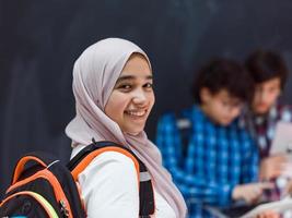 los adolescentes árabes modernos usan teléfonos inteligentes, tabletas y latpop para estudiar durante las clases en línea debido a la pandemia del virus de la corona foto