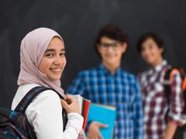 Arabic teenagers team, students group working together on laptop and tablet computer online classroom education concept. Selective focus photo