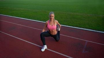 sporty woman on athletic race track photo