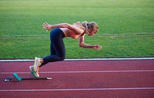 pixelated design of woman  sprinter leaving starting blocks photo