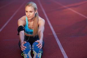sporty woman on athletic race track photo