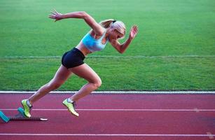 pixelated design of woman  sprinter leaving starting blocks photo