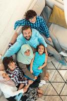 Top view photo of an Arab family sitting in the living room of a large modern house.Selective focus