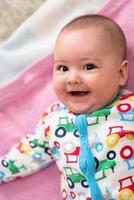 top view of newborn baby boy lying on colorful blankets photo