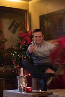 Happy young man with a glass of champagne photo