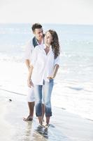 happy young couple have fun at beautiful beach photo