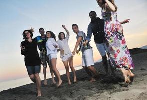 Group of young people enjoy summer  party at the beach photo