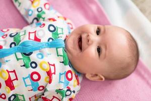 top view of newborn baby boy lying on colorful blankets photo