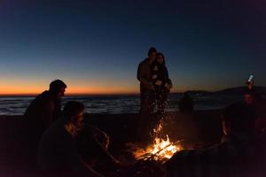 Friends having fun at beach on autumn day photo