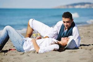 happy young couple have fun at beautiful beach photo